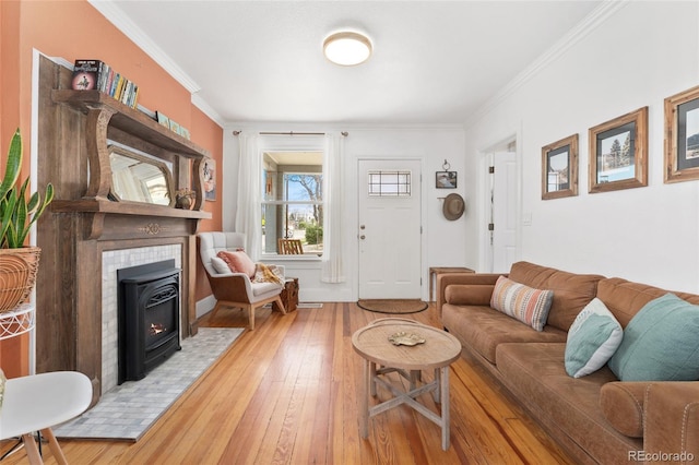 3059 N Humboldt St, Denver, CO 80205 - living area featuring a tile fireplace, ornamental molding, and hardwood / wood-style floors