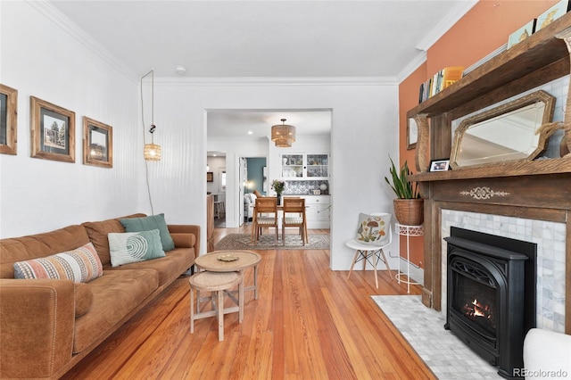 3059 N Humboldt St, Denver, CO 80205 - living room with light wood-style floors, crown molding, and a tiled fireplace
