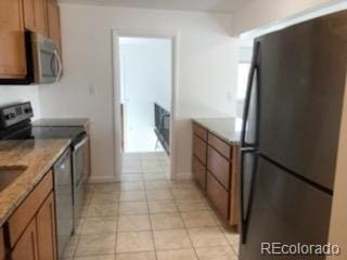 kitchen with light tile patterned floors and appliances with stainless steel finishes