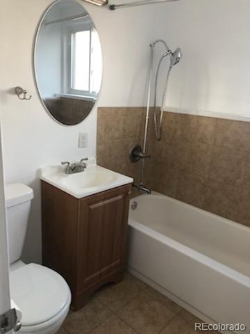 full bathroom featuring tile patterned floors, shower / bath combination, toilet, and vanity