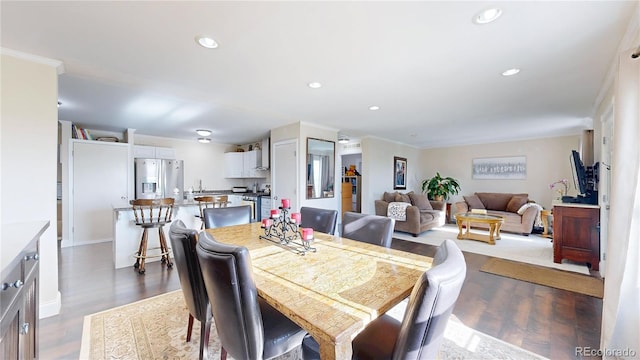 66095 E Kettle Pl, Byers, CO 80103 - dining area featuring recessed lighting, dark wood-style flooring, and ornamental molding