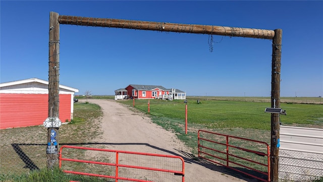 66095 E Kettle Pl, Byers, CO 80103 - view of dirt / gravel road with a gated entry and a view of countryside