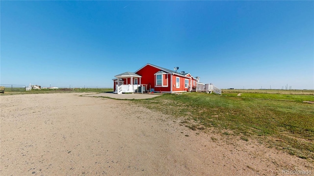 66095 E Kettle Pl, Byers, CO 80103 - view of side of home featuring a lawn and a rural view