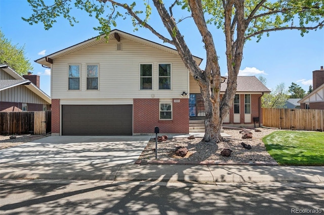 3832 S Quebec St, Denver, CO 80237 - view of front facade with brick siding, fence, and concrete driveway