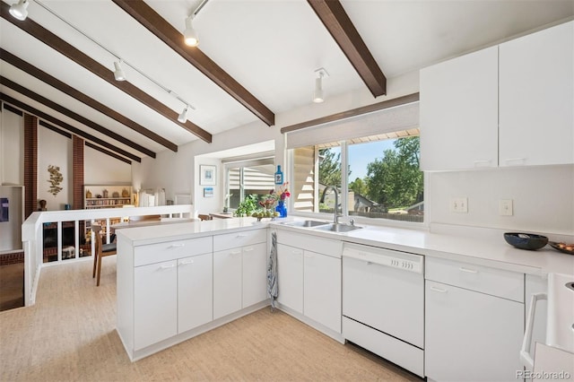 3832 S Quebec St, Denver, CO 80237 - kitchen featuring dishwasher, a sink, a peninsula, light countertops, and white cabinetry