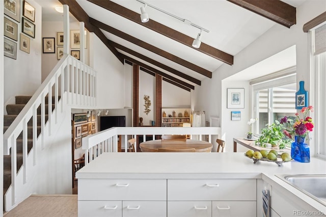 3832 S Quebec St, Denver, CO 80237 - kitchen featuring light countertops, white cabinetry, rail lighting, and a peninsula