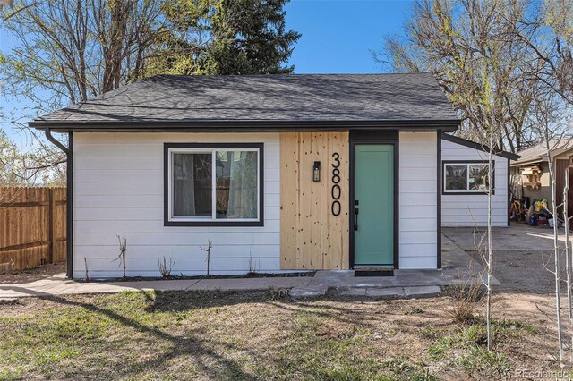3800 W Eisenhower Blvd, Loveland, CO 80537 - bungalow-style home with roof with shingles, a front yard, and fence