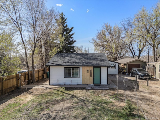 3800 W Eisenhower Blvd, Loveland, CO 80537 - view of outdoor structure with dirt driveway, fence, and a garage