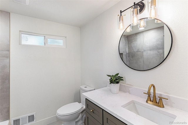 3800 W Eisenhower Blvd, Loveland, CO 80537 - bathroom with visible vents, toilet, vanity, and a textured wall
