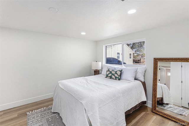 3800 W Eisenhower Blvd, Loveland, CO 80537 - bedroom with baseboards, recessed lighting, and wood finished floors