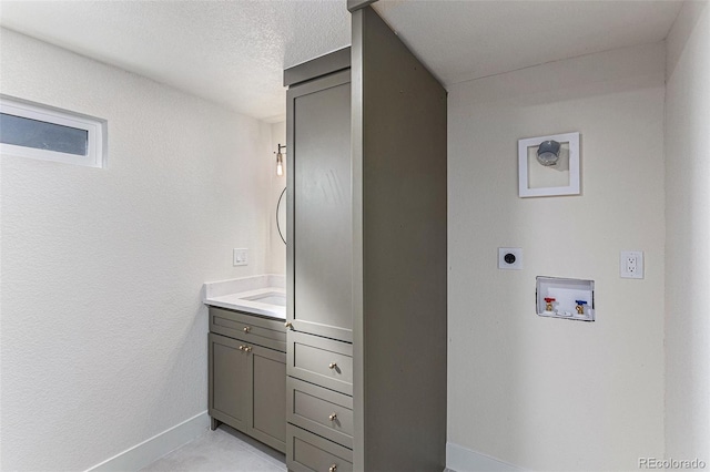 3800 W Eisenhower Blvd, Loveland, CO 80537 - bathroom featuring a textured wall, vanity, a textured ceiling, and baseboards