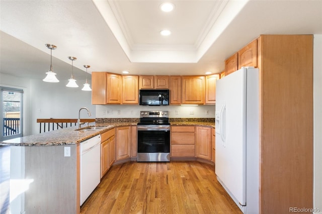 kitchen featuring crown molding, a raised ceiling, a sink, white appliances, and a peninsula