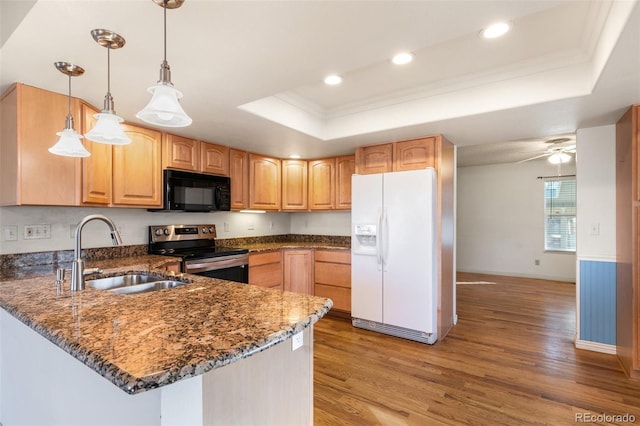 kitchen with black microwave, white refrigerator with ice dispenser, a sink, a raised ceiling, and stainless steel range with electric stovetop