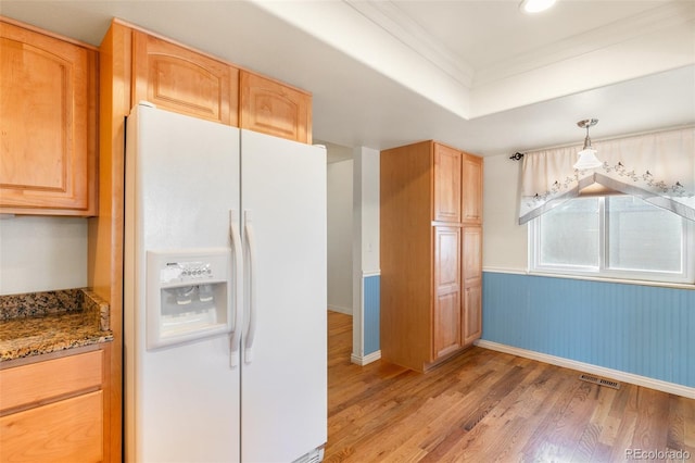 kitchen with light wood finished floors, stone countertops, visible vents, a raised ceiling, and white fridge with ice dispenser