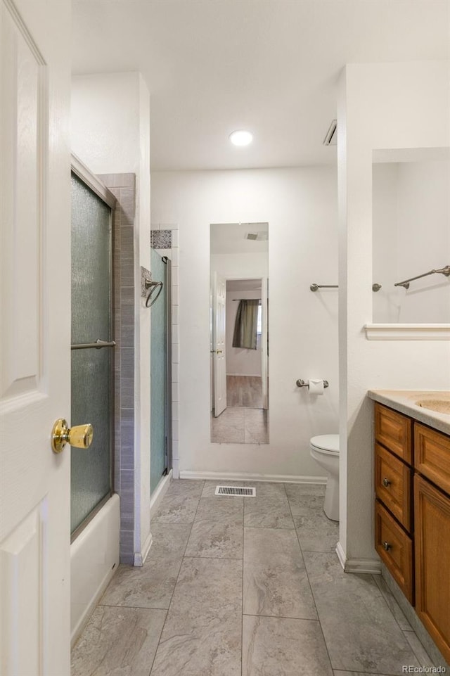 bathroom featuring visible vents, toilet, an enclosed shower, vanity, and baseboards