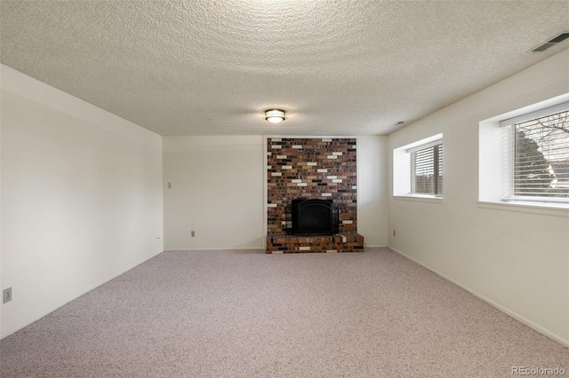 unfurnished living room featuring a brick fireplace, visible vents, carpet flooring, and a healthy amount of sunlight