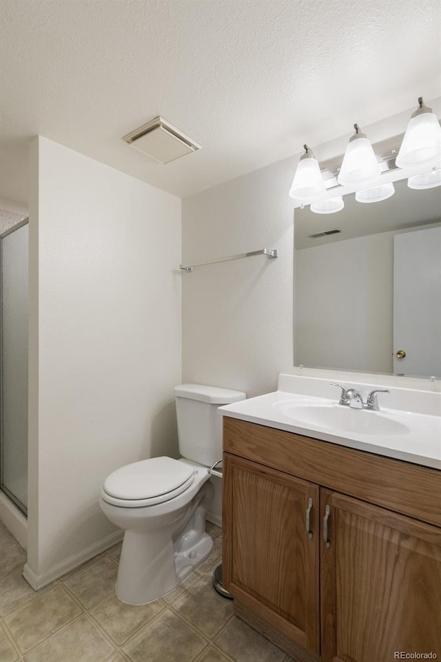 full bath with a textured ceiling, toilet, vanity, tile patterned floors, and a stall shower