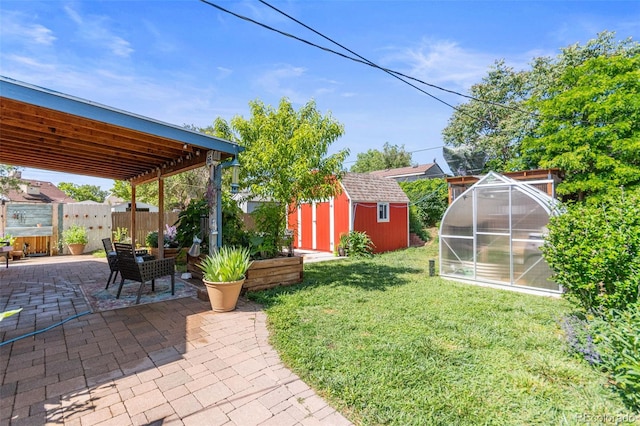 4163 S Decatur St, Englewood, CO 80110 - view of yard featuring a patio, an exterior structure, and a storage unit