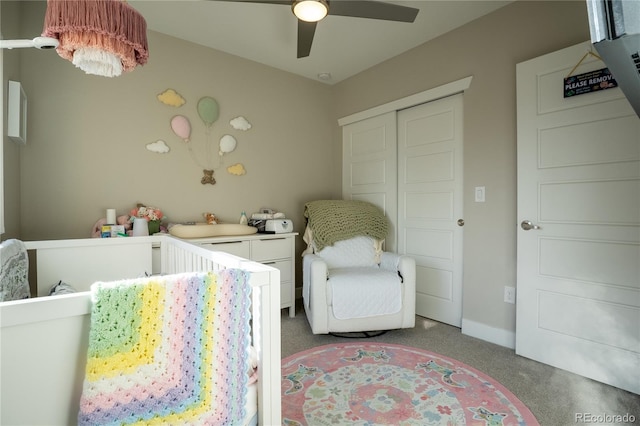 bedroom featuring ceiling fan, a nursery area, and a closet