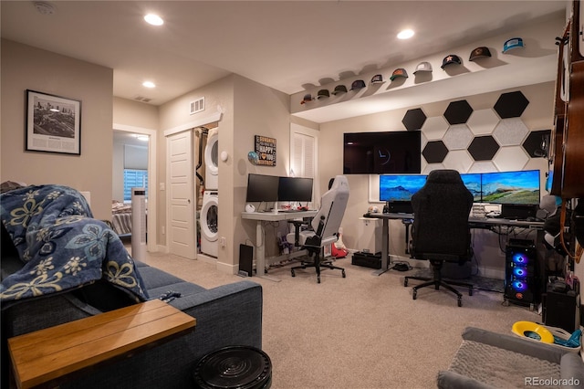 carpeted office featuring stacked washing maching and dryer