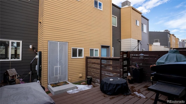 wooden deck featuring a grill