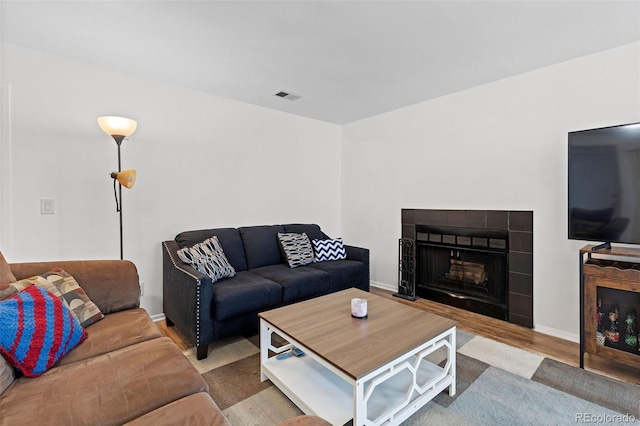 3021 S Ursula Cir Unit 102, Aurora, CO 80014 - living room with wood finished floors, baseboards, and a tile fireplace