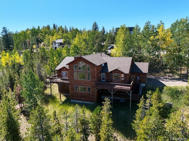 rear view of property with a wooden deck