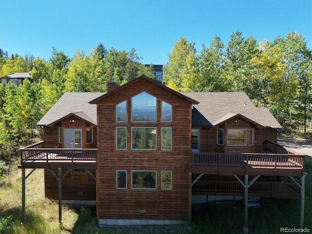 rear view of property featuring a deck