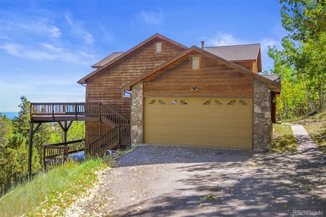 view of front of house featuring a deck and a garage