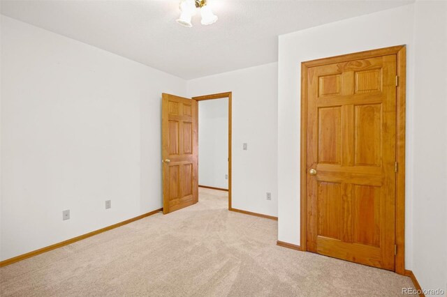 unfurnished bedroom with light colored carpet