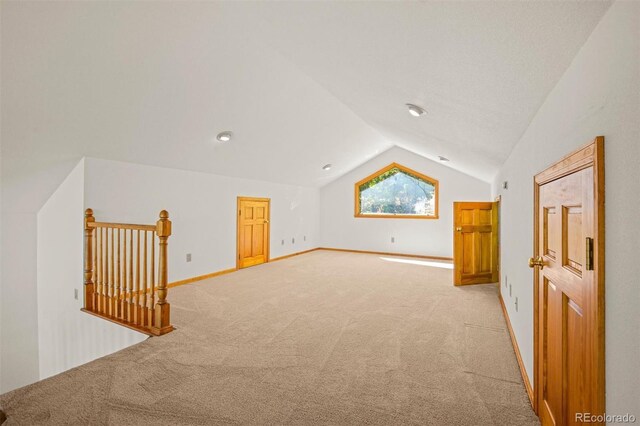 bonus room featuring light colored carpet and lofted ceiling