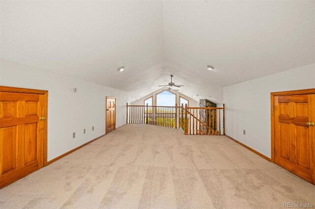 additional living space with ceiling fan, lofted ceiling, and light carpet