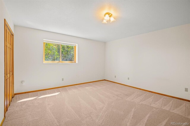 unfurnished room with light carpet