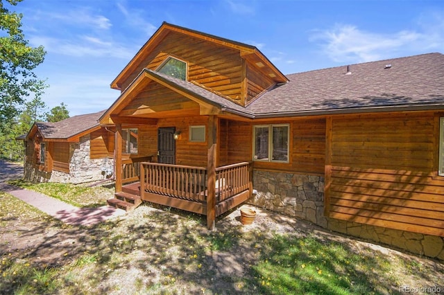10333 Georgia Cir, Morrison, CO 80465 - back of property with roof with shingles, a wooden deck, and stone siding