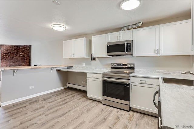 kitchen featuring appliances with stainless steel finishes, light hardwood / wood-style flooring, white cabinetry, a baseboard radiator, and sink