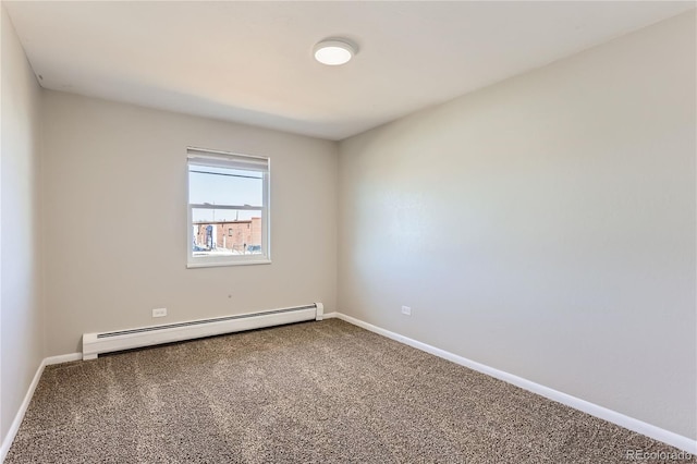 carpeted spare room with a baseboard heating unit