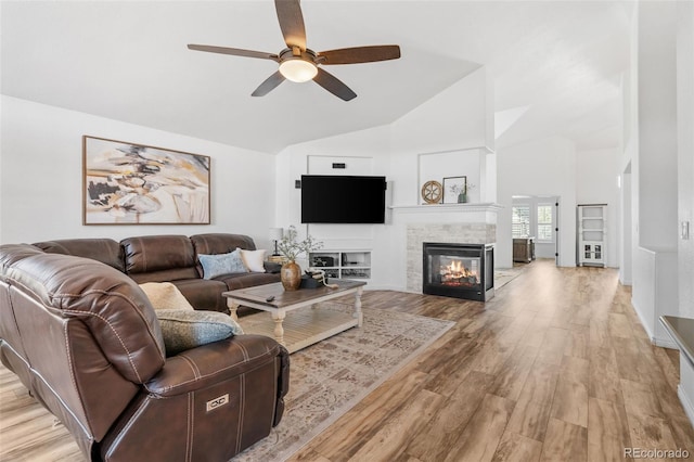 9576 E 147th Pl, Brighton, CO 80602 - living area with a ceiling fan, light wood-type flooring, a multi sided fireplace, and high vaulted ceiling