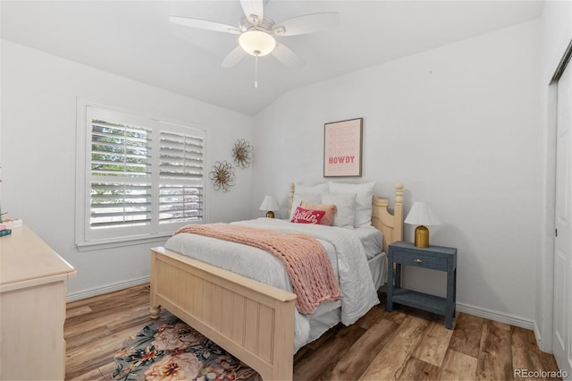 9576 E 147th Pl, Brighton, CO 80602 - bedroom with light wood finished floors, vaulted ceiling, and ceiling fan