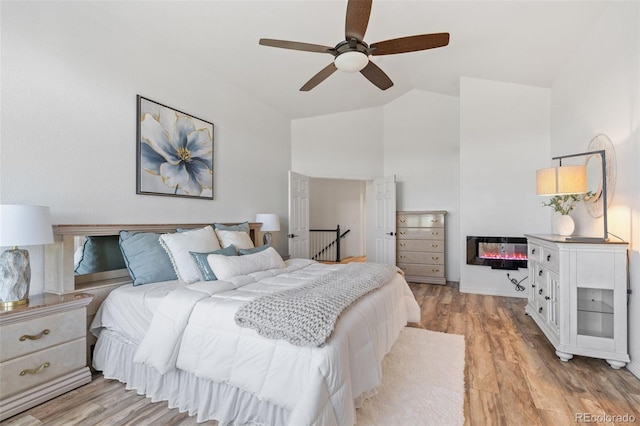 9576 E 147th Pl, Brighton, CO 80602 - bedroom with light wood-style flooring, high vaulted ceiling, and ceiling fan