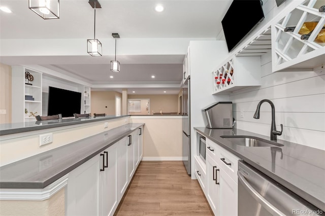 9576 E 147th Pl, Brighton, CO 80602 - kitchen with stainless steel appliances, pendant lighting, white cabinetry, light wood-style flooring, and recessed lighting