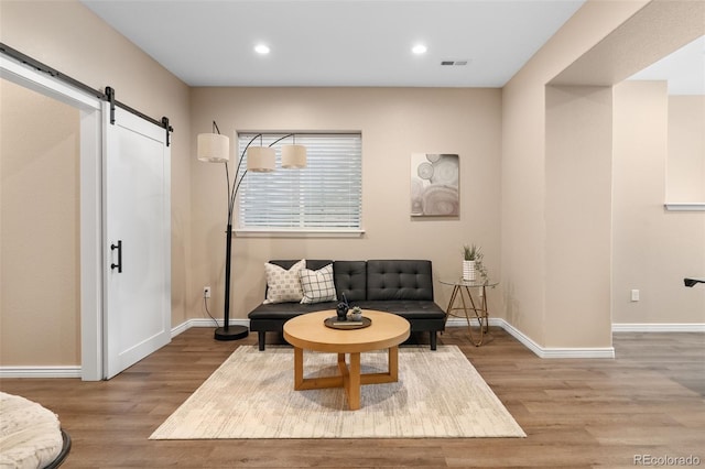 9576 E 147th Pl, Brighton, CO 80602 - living area with a barn door, wood finished floors, and recessed lighting