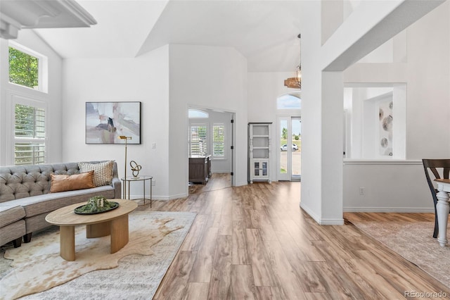 9576 E 147th Pl, Brighton, CO 80602 - living room with a towering ceiling, light wood-style floors, and a chandelier