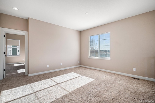 carpeted empty room featuring plenty of natural light