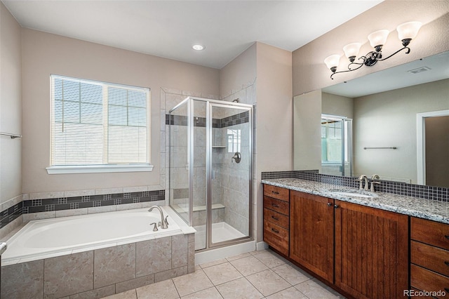 bathroom featuring tile patterned flooring, vanity, and separate shower and tub