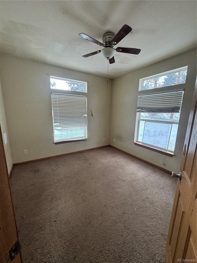 empty room with ceiling fan and carpet floors