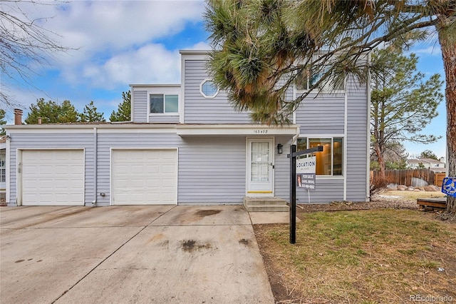 view of front of house featuring a garage and a front lawn