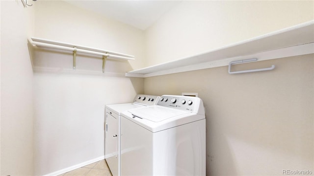 laundry area featuring washer and clothes dryer and light tile patterned floors