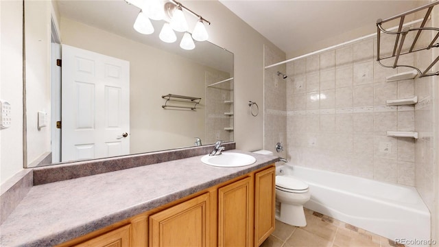 full bathroom with tile patterned floors, vanity, tiled shower / bath combo, and toilet