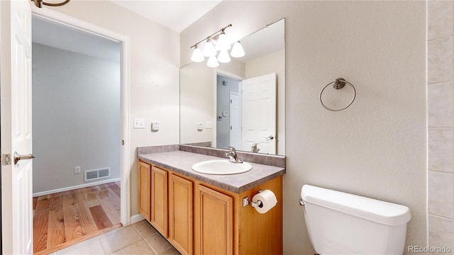 bathroom featuring tile patterned floors, vanity, and toilet