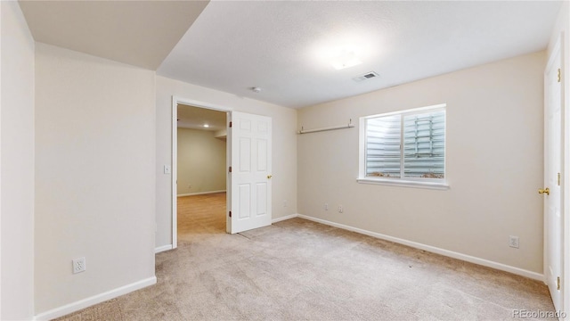 unfurnished bedroom with light colored carpet